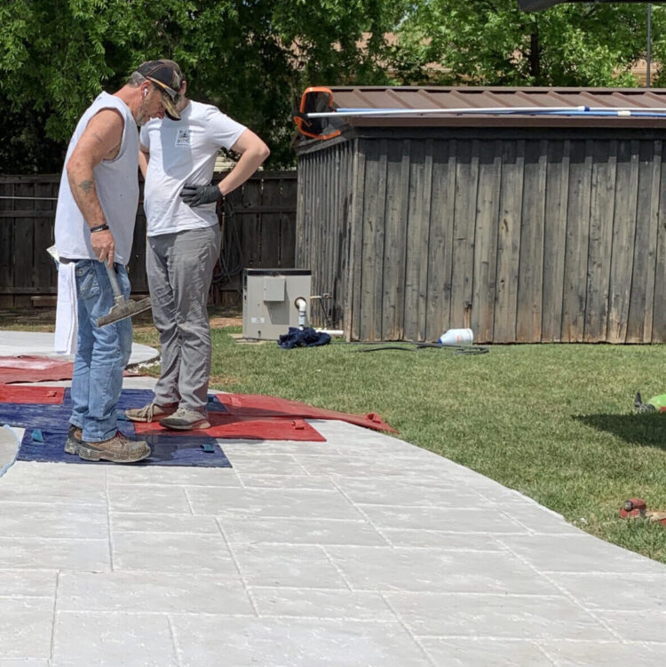 men working outside with concrete flooring